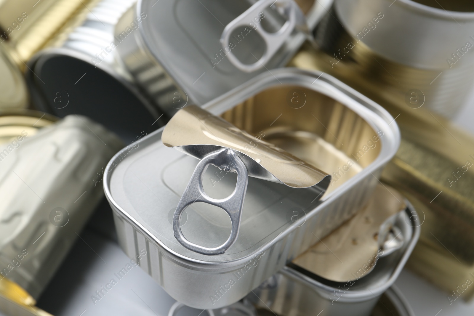 Photo of Many open tin cans as background, closeup