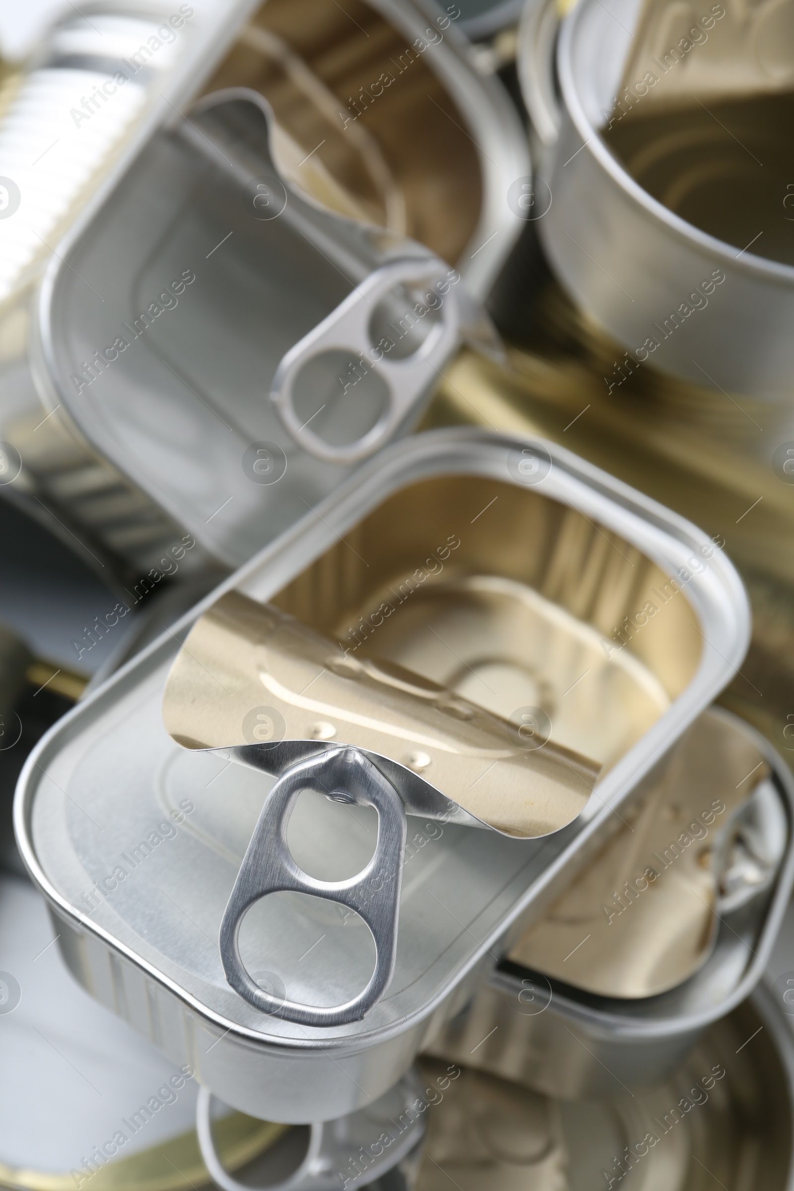 Photo of Many open tin cans as background, closeup