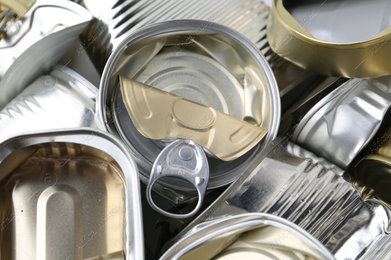 Photo of Many crumpled tin cans as background, closeup