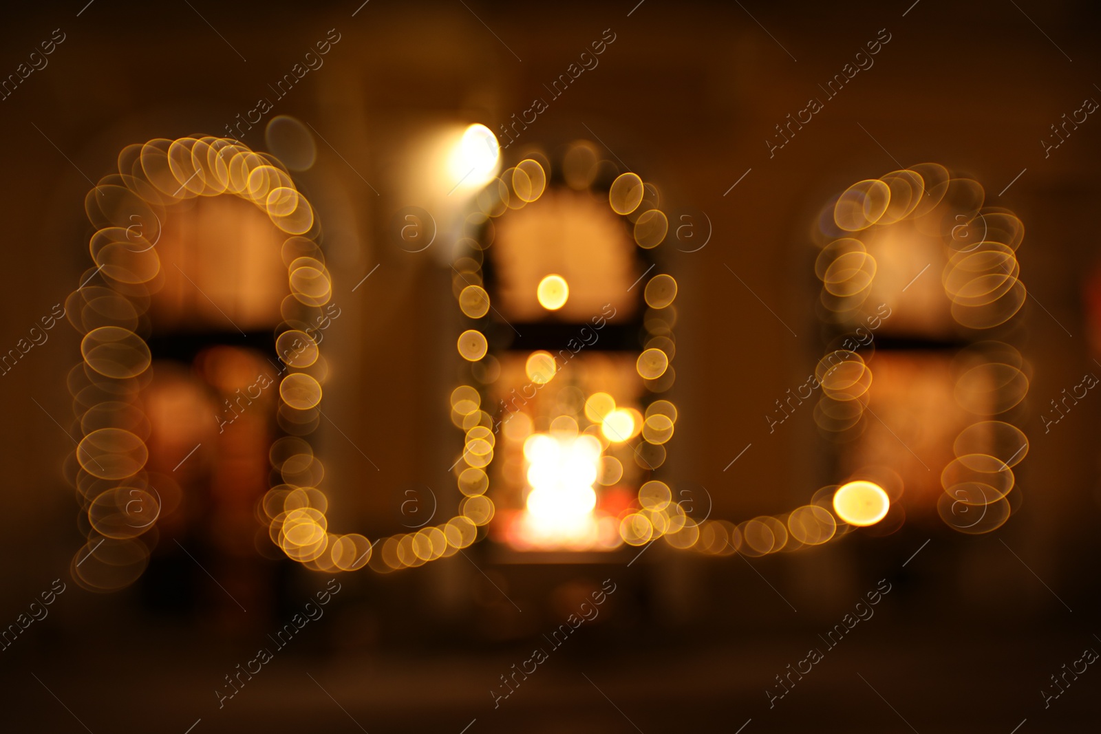 Photo of Blurred view of windows with festive lights, bokeh effect