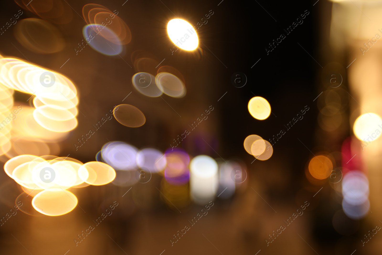 Photo of Blurred view of city street at night. Bokeh effect