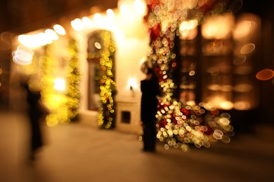 Photo of Defocused view of building with festive lights, bokeh effect