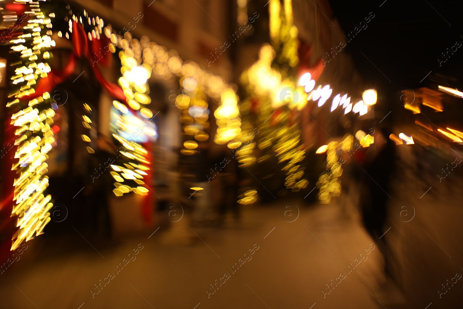 Photo of Defocused view of building with festive lights, motion blur and bokeh effect