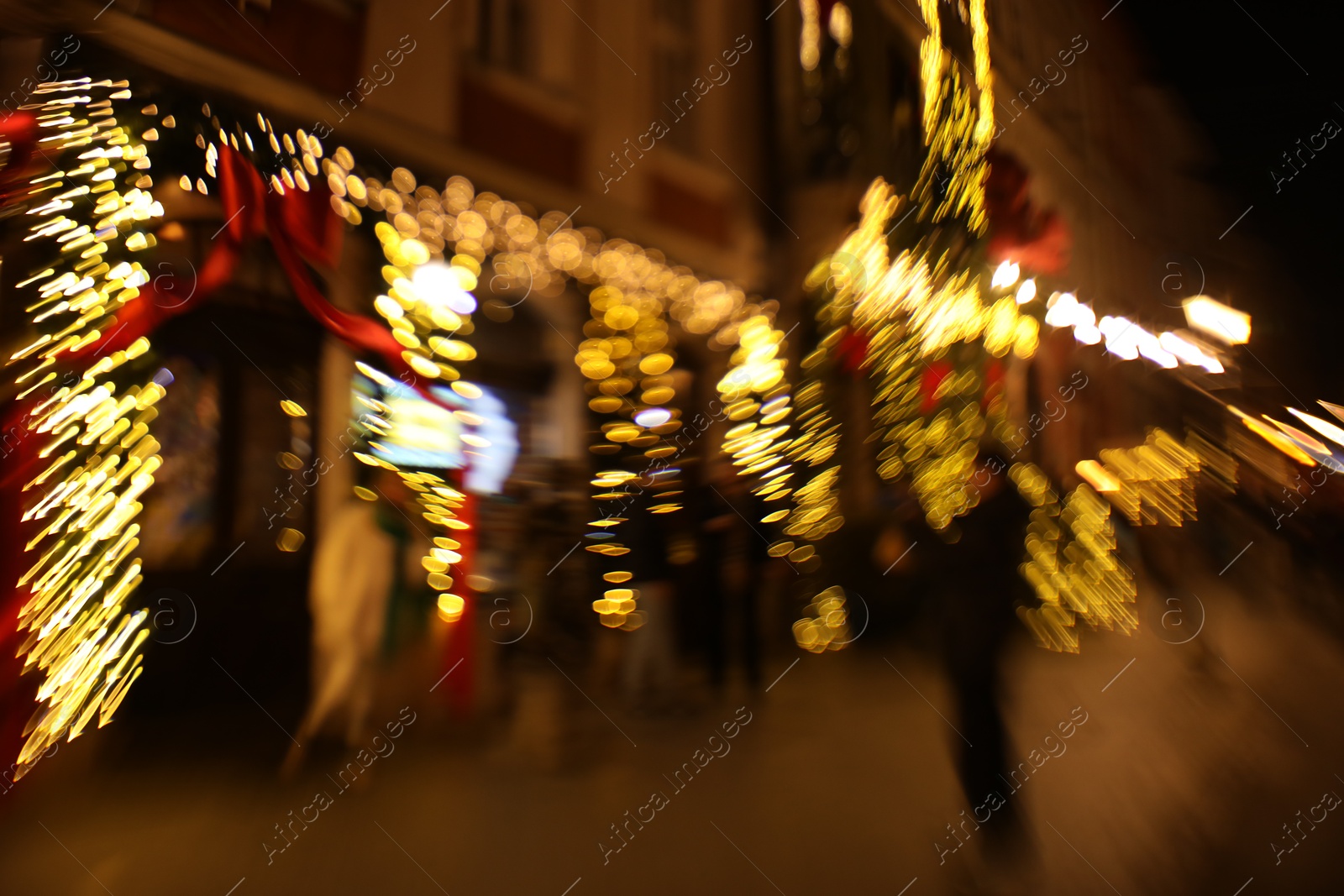 Photo of Defocused view of building with festive lights, motion blur and bokeh effect