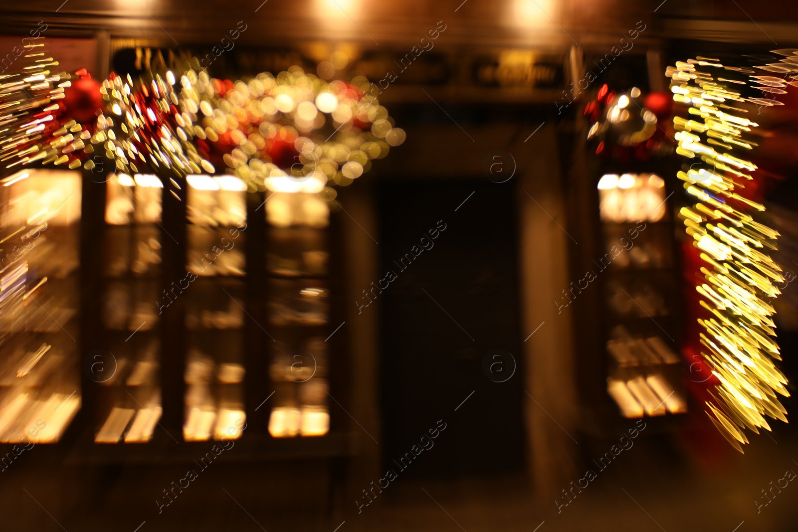 Photo of Defocused view of building with festive lights, motion blur and bokeh effect