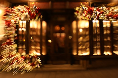 Photo of Defocused view of building with festive lights, motion blur and bokeh effect