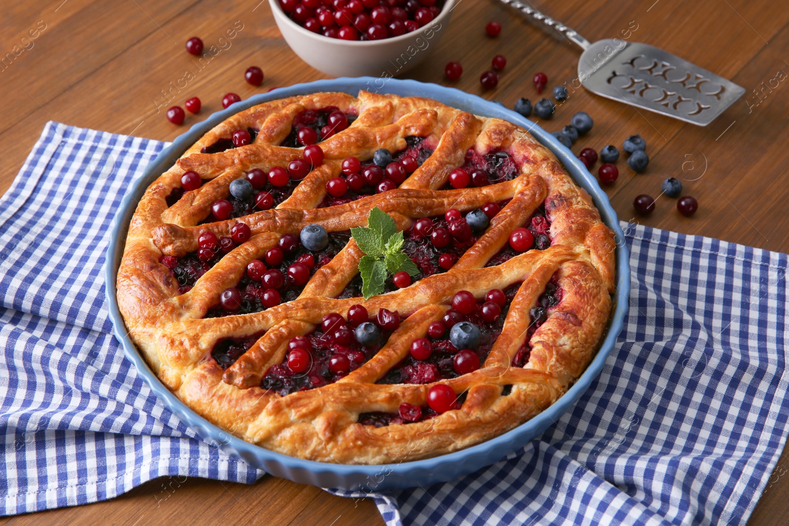 Photo of Delicious currant pie with fresh berries on wooden table