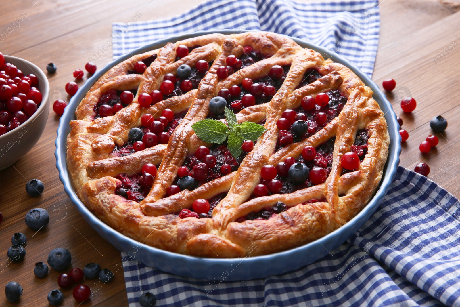 Photo of Delicious currant pie with fresh berries on wooden table