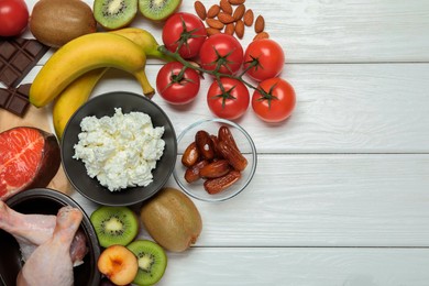 Photo of Different fresh products rich in serotonin on white wooden table, flat lay. Space for text