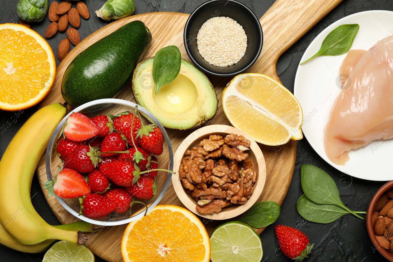 Photo of Different fresh products rich in dopamine on grey textured table, flat lay