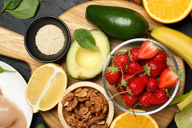 Photo of Different fresh products rich in dopamine on grey textured table, flat lay