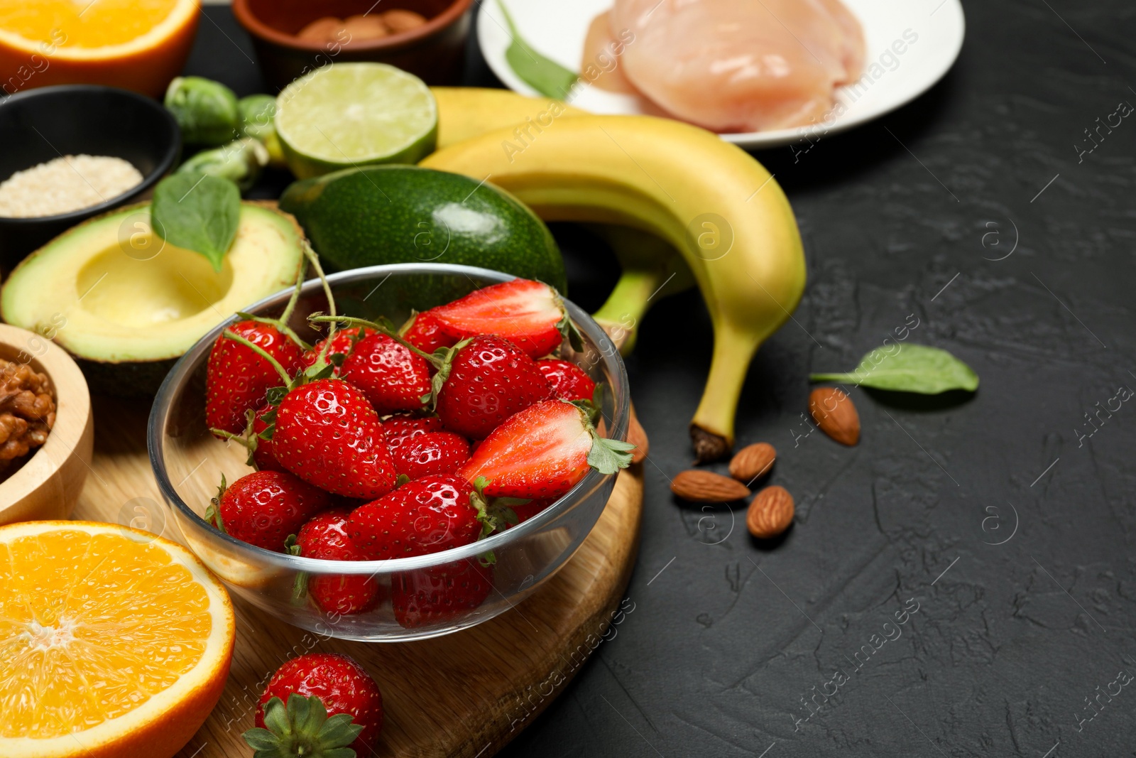 Photo of Different fresh products rich in dopamine on grey textured table. Space for text