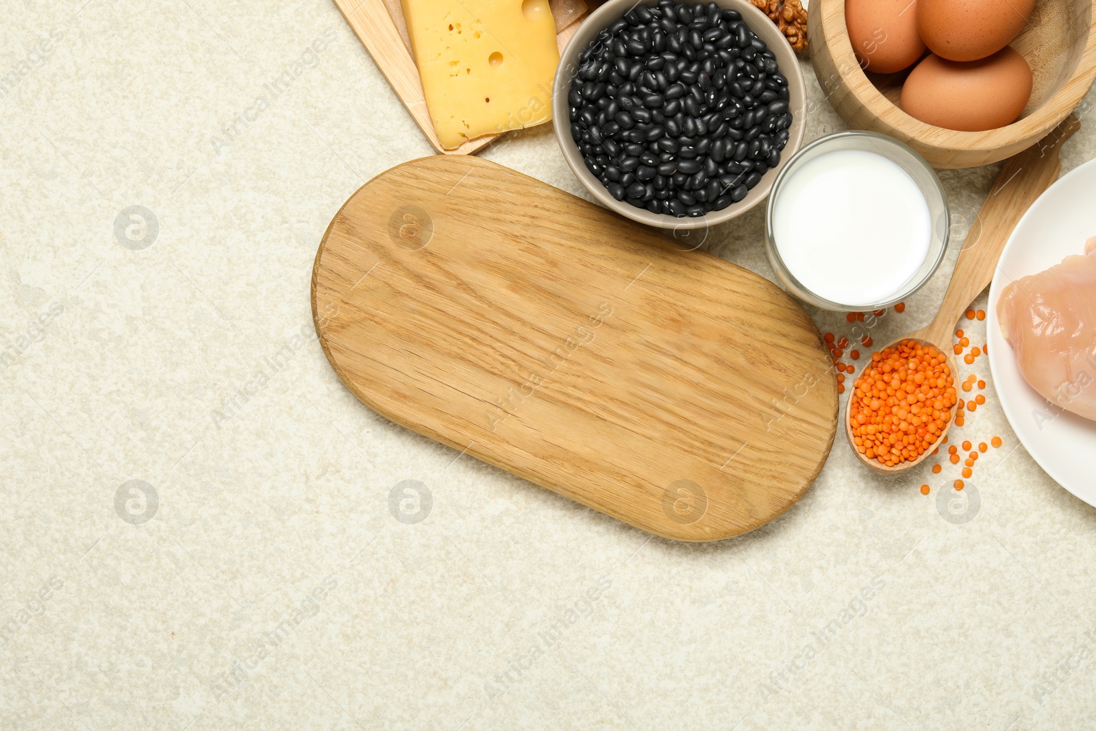 Photo of Wooden board with word Estrogen and different fresh products on light textured table, flat lay. Space for text