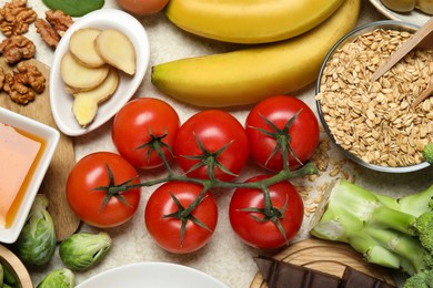 Photo of Different fresh products rich in melatonin on light table, flat lay