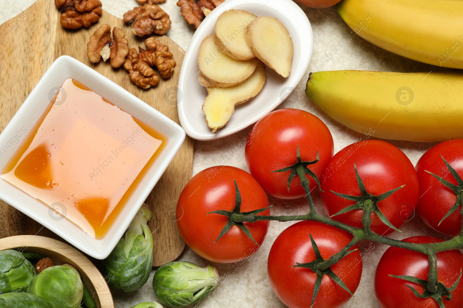 Photo of Different fresh products rich in melatonin on light table, flat lay