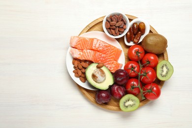 Photo of Different products rich in serotonin on white wooden table, top view. Space for text