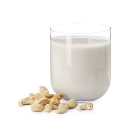 Fresh cashew milk in glass and nuts isolated on white