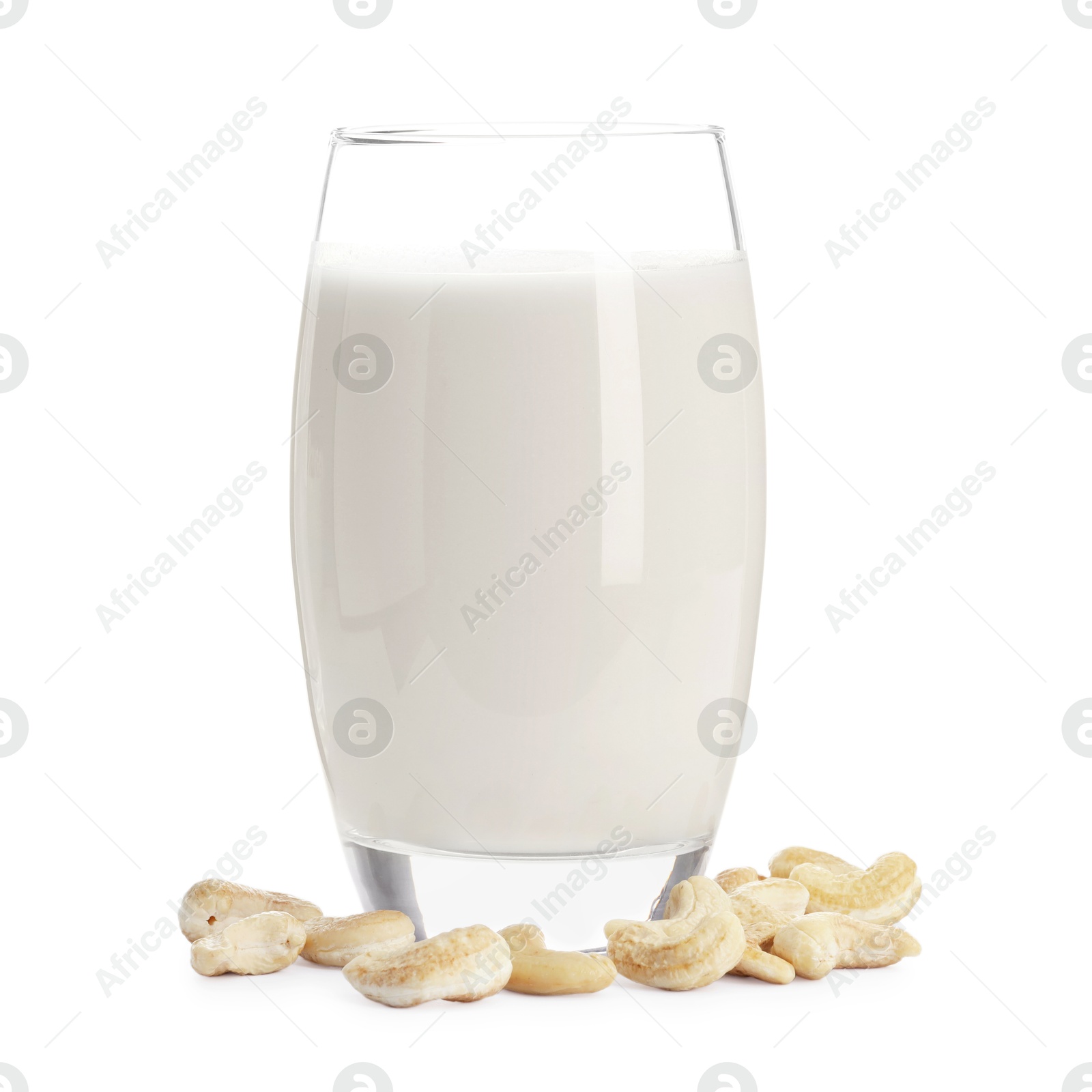 Photo of Fresh cashew milk in glass and nuts isolated on white