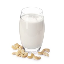 Photo of Fresh cashew milk in glass and nuts isolated on white