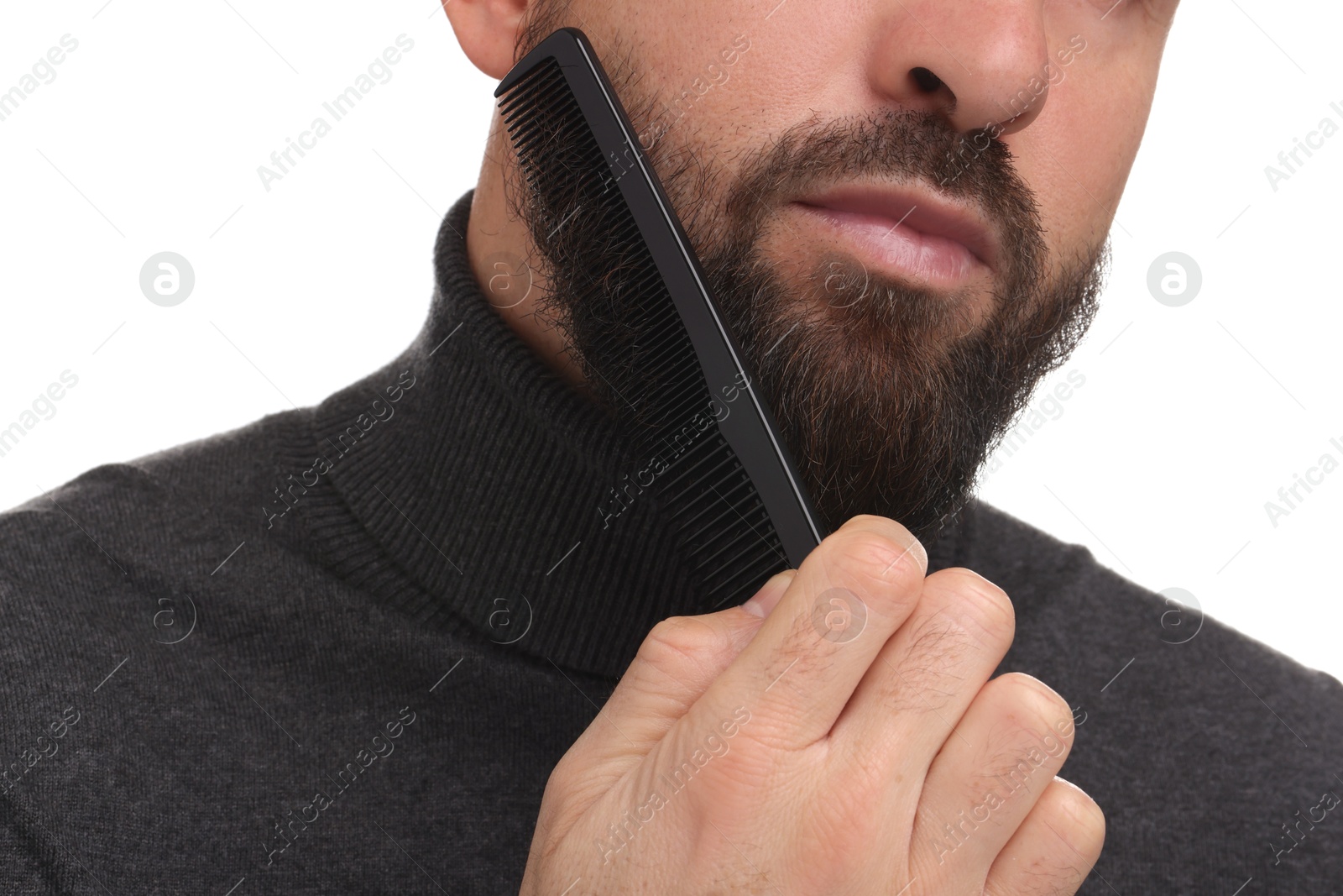 Photo of Man combing beard on white background, closeup