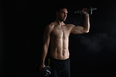 Photo of Man training with barbell on black background