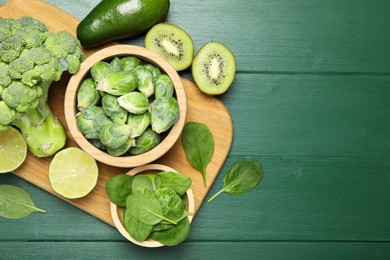 Photo of Different fresh healthy products on green wooden table, flat lay. Space for text