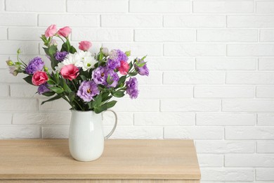 Photo of Vase with beautiful eustoma flowers on wooden chest of drawers, space for text