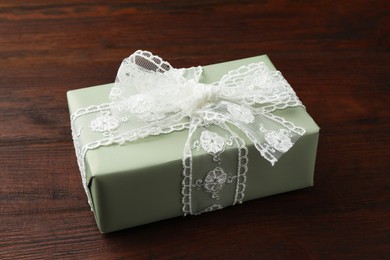 Gift box with bow on wooden table