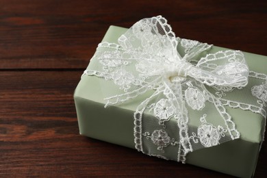 Photo of Gift box with bow on wooden table