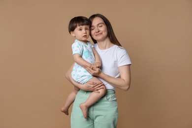 Photo of Family portrait of mother with her little son on beige background