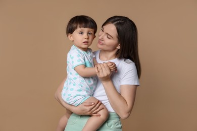 Photo of Family portrait of mother with her little son on beige background