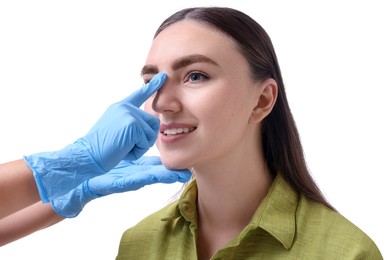 Photo of Doctor checking patient's nose before plastic surgery operation on white background, closeup