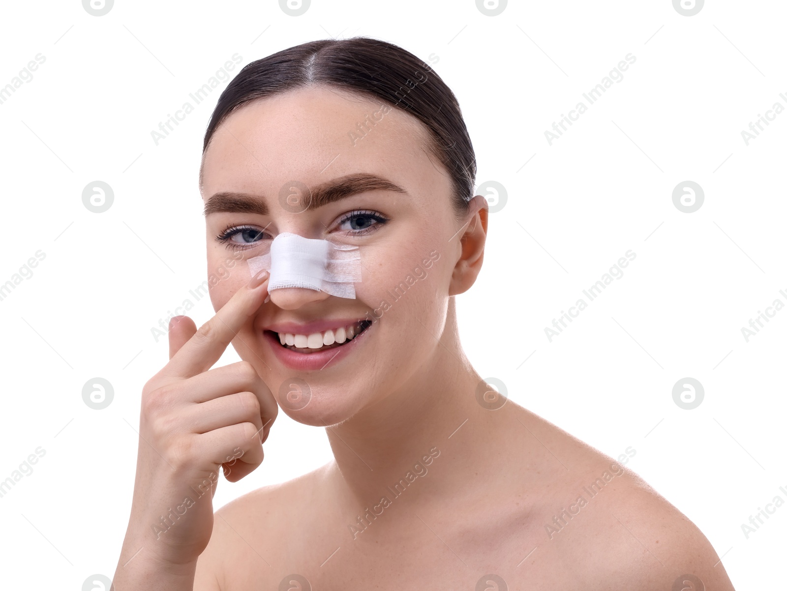 Photo of Woman with medical bandage on her nose after plastic surgery operation against white background