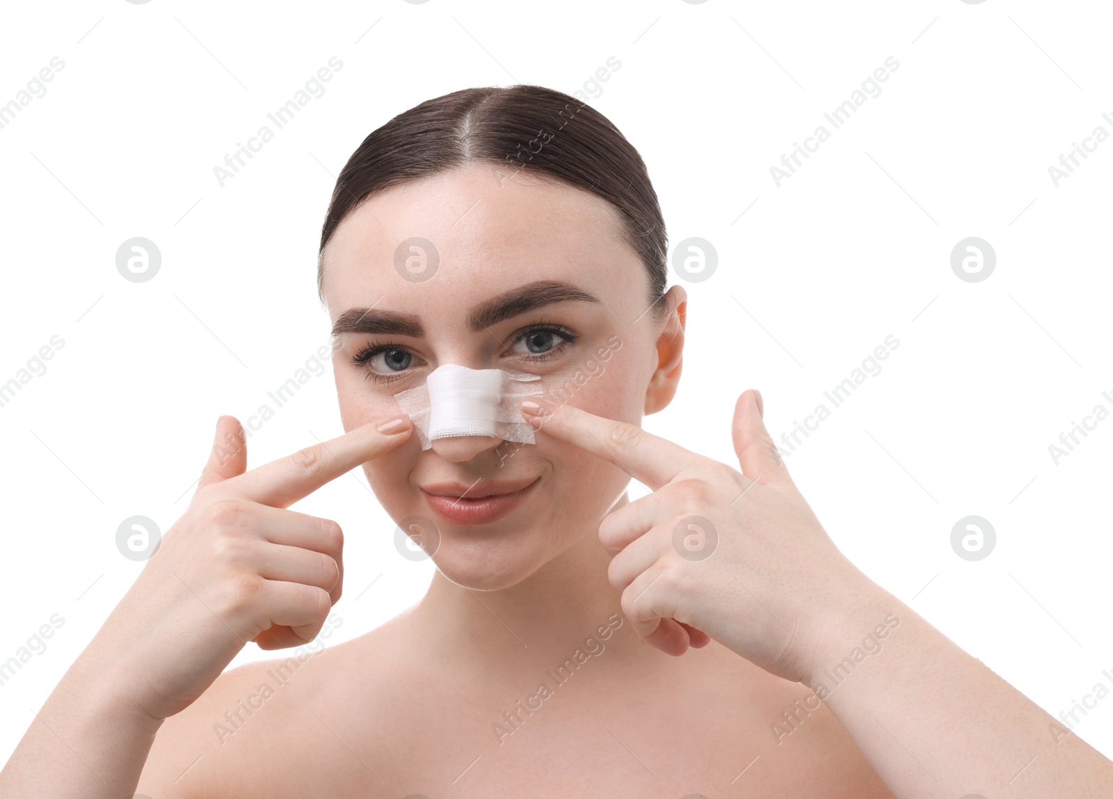 Photo of Woman with medical bandage on her nose after plastic surgery operation against white background