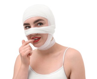 Photo of Woman with nose wrapped in medical bandage after plastic surgery operation on white background