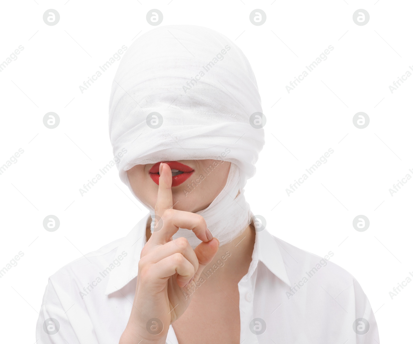 Photo of Woman with face wrapped in medical bandage after plastic surgery operation making silent gesture on white background