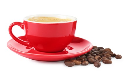 Photo of Red cup of aromatic coffee, saucer and beans isolated on white