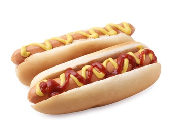 Photo of Tasty hot dogs with ketchup and mustard isolated on white