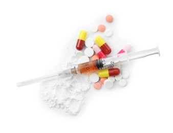 Photo of Drug addiction. Different pills, syringe and powder isolated on white, top view