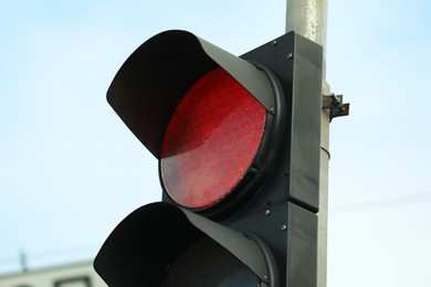 Photo of Traffic light against blue sky in city, closeup