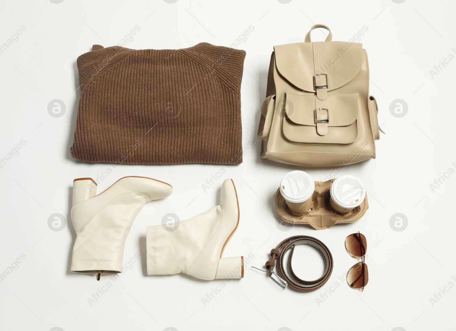 Photo of Stylish outfit with backpack on white background, flat lay