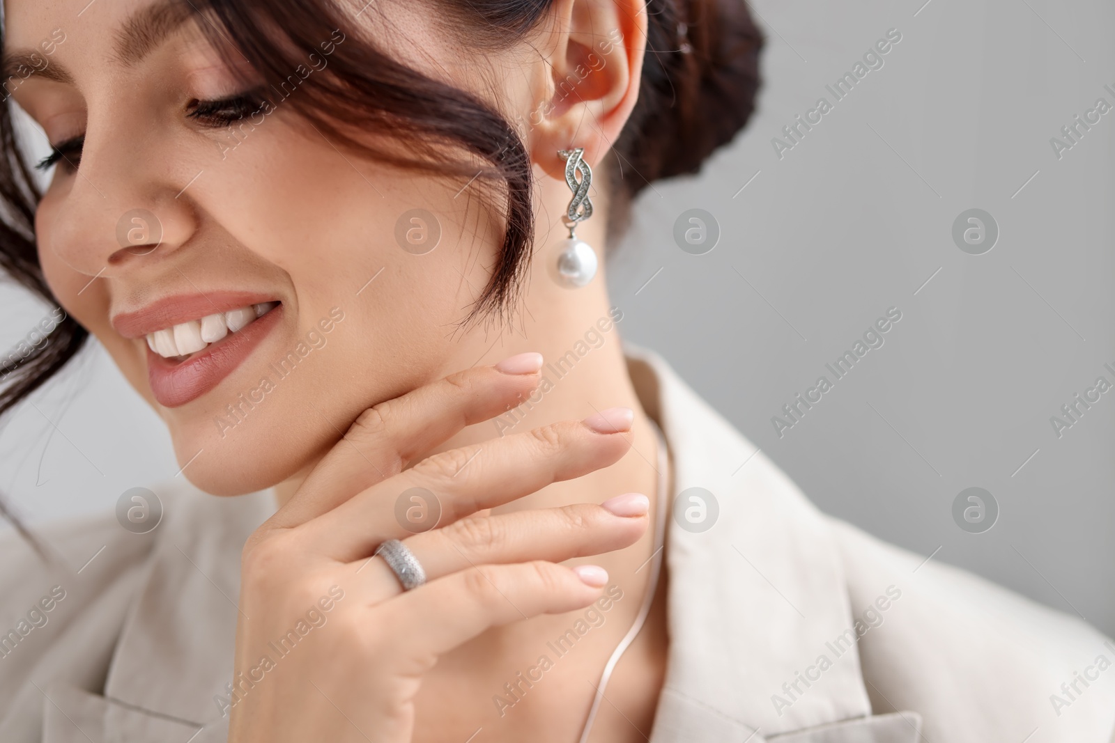 Photo of Beautiful young woman wearing elegant jewelry indoors, closeup