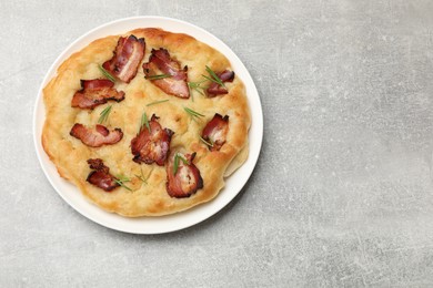 Photo of Delicious focaccia bread with bacon and parsley on light grey table, top view. Space for text