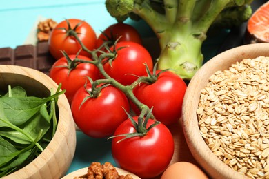 Photo of Different fresh products rich in melatonin on light blue table, closeup