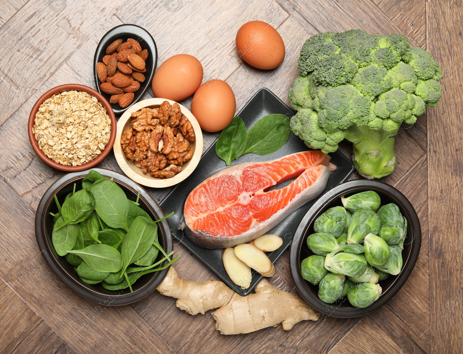 Photo of Different fresh products rich in melatonin on wooden table, flat lay