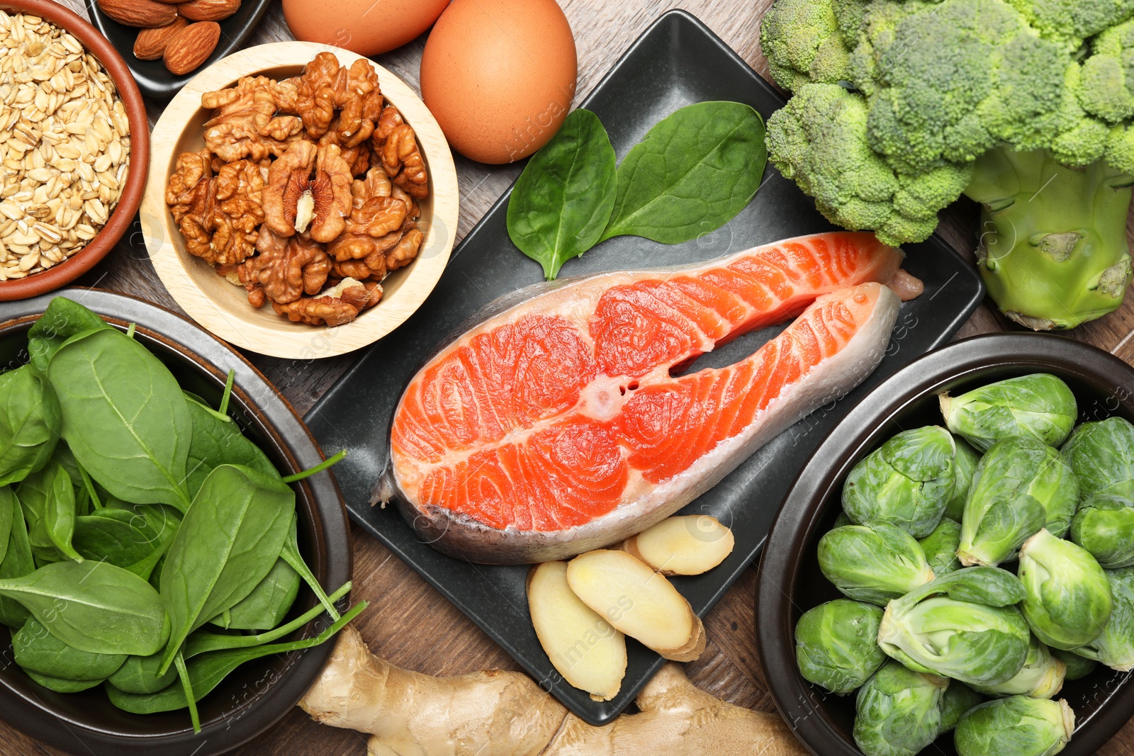 Photo of Different fresh products rich in melatonin on wooden table, flat lay