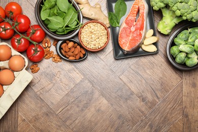 Photo of Different fresh products rich in melatonin on wooden table, flat lay. Space for text