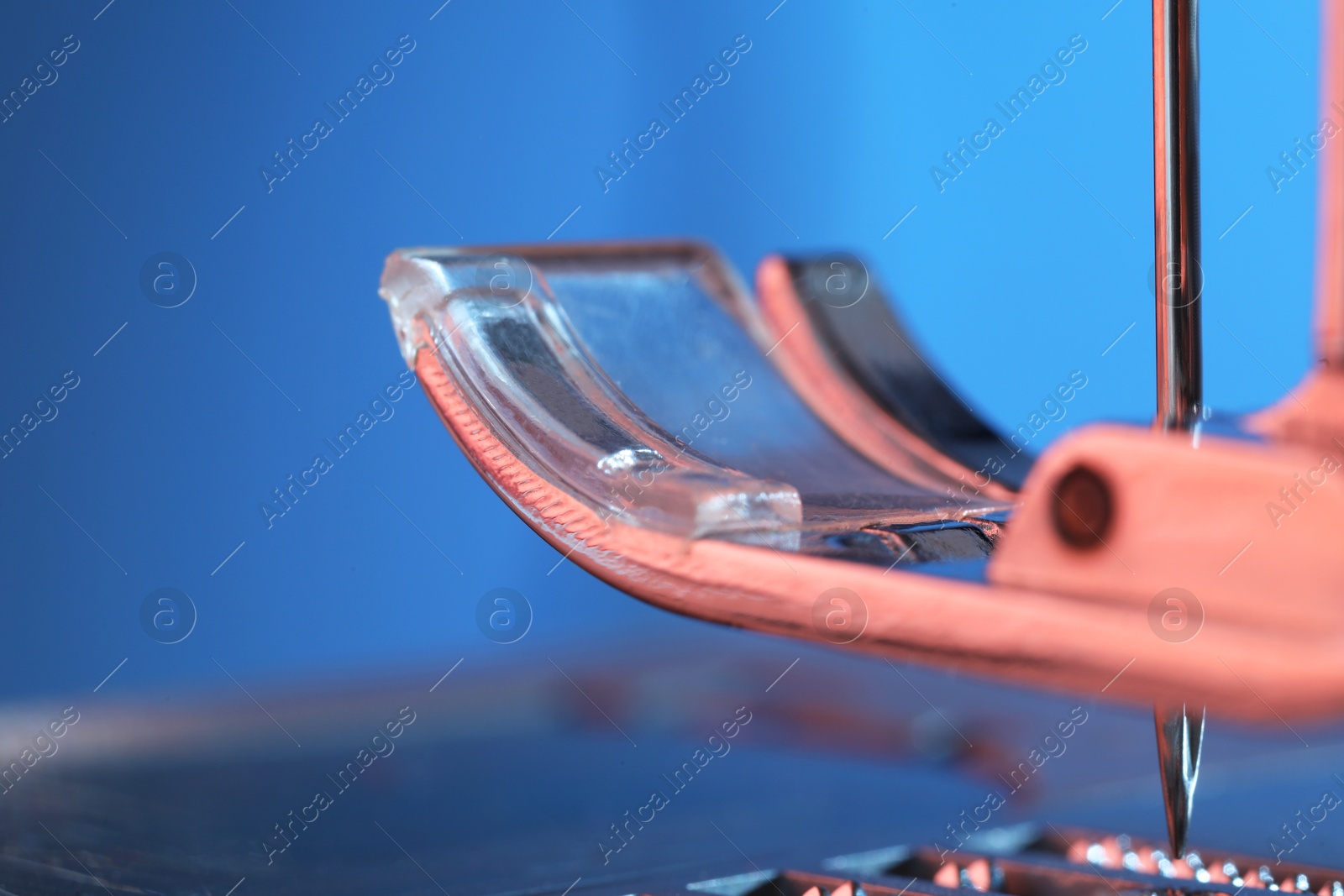 Photo of Sewing machine on light blue background, macro view