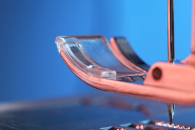 Photo of Sewing machine on light blue background, macro view