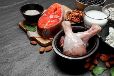 Photo of Different fresh products rich in estrogen on grey textured table. Space for text